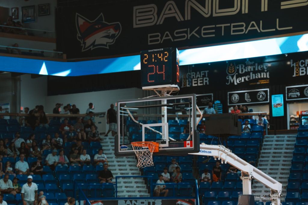 indoor basketball court with scoreboard and audience
