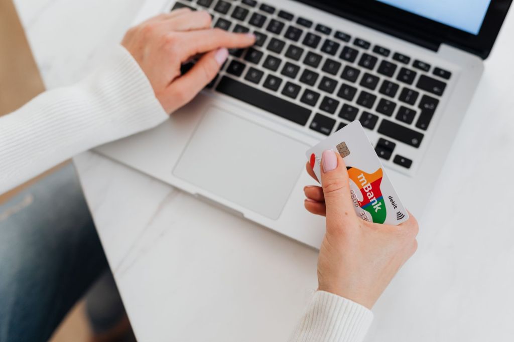 a person holding a bank card