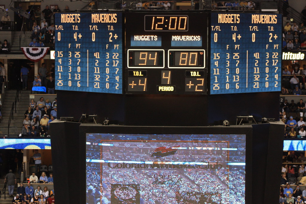 Arena scoreboard showing a Nuggets vs. Mavericks final, 94 to 80